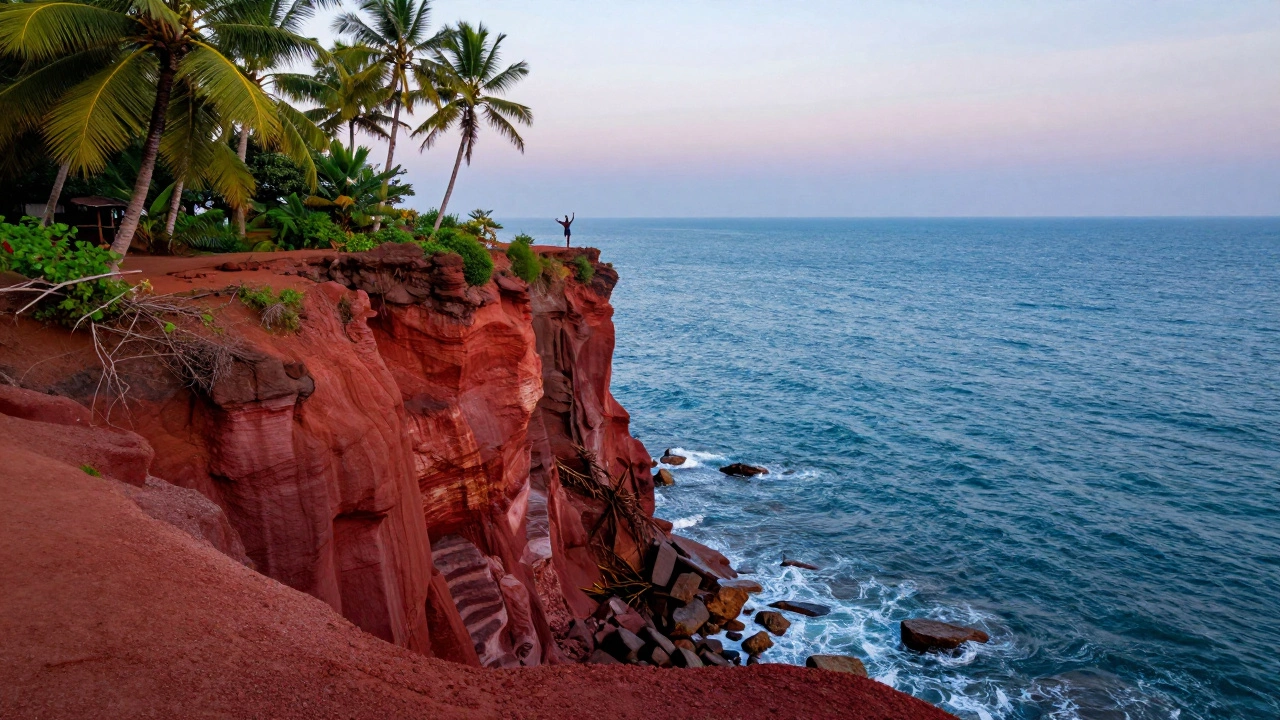 Red sedimentary cliffs of Varkala overlooking the blue Arabian Sea with palm trees.
