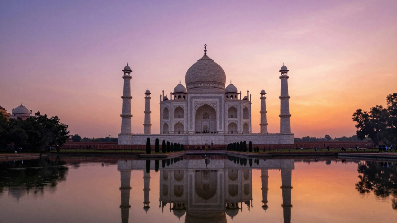 The Taj Mahal reflecting in the Yamuna River during a colorful sunset.