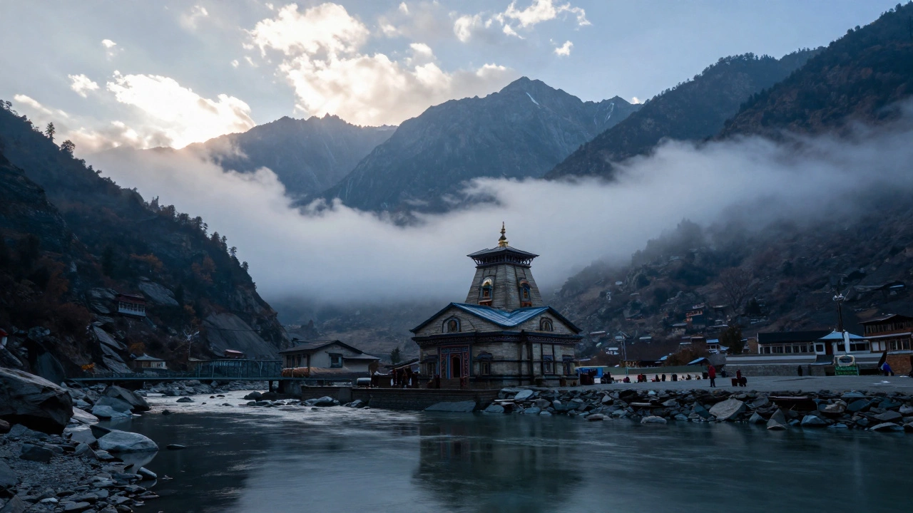 Badrinath temple with clear skies and misty mountains in autumn